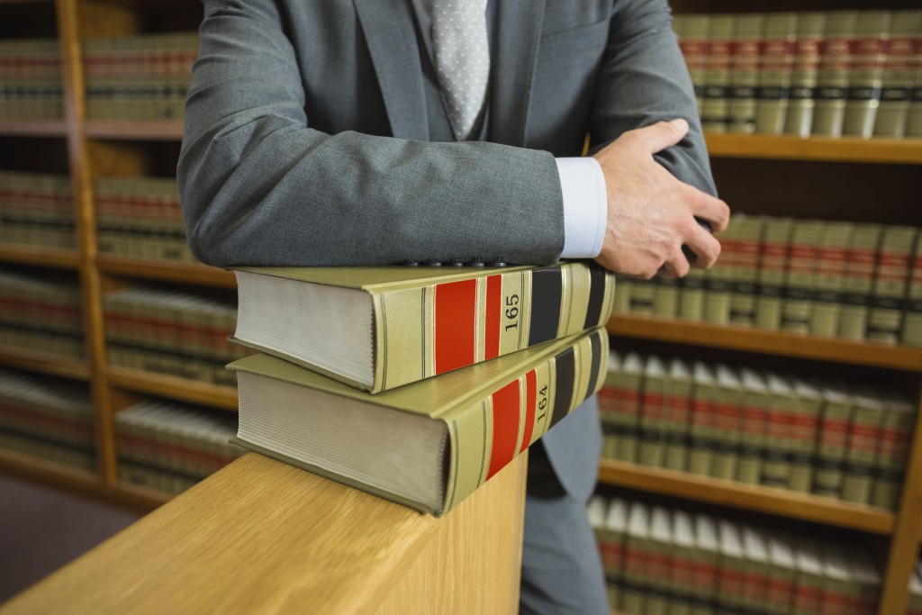 Lawyer-standing-in-the-law-library-000058568674_Full